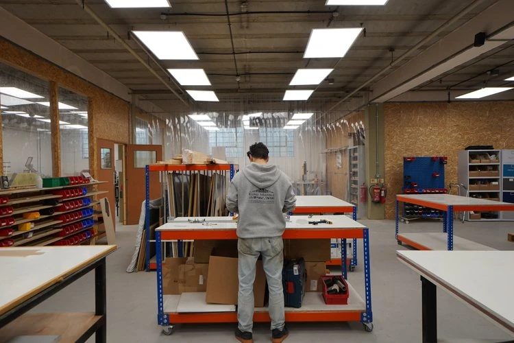 A maker working at the central workshop bench.