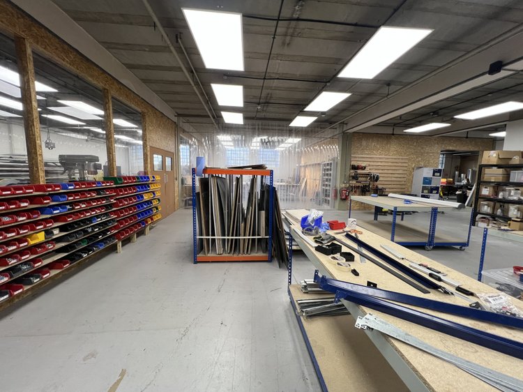 Workshop aisle between parts storage and workbenches.