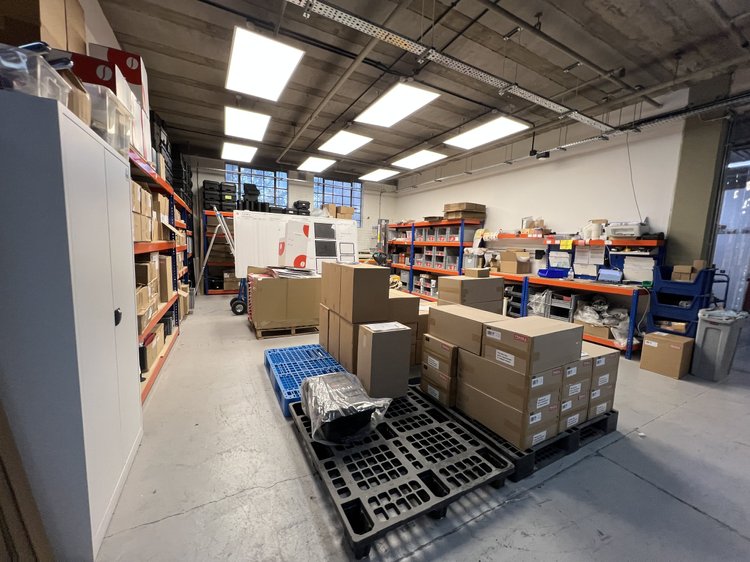 Workshop storage area with boxed materials and pallets.